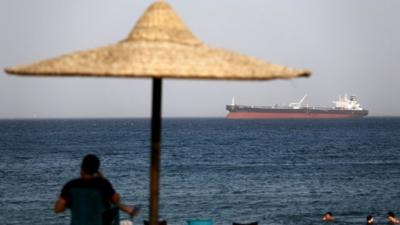 The beach in El Ain El Sokhna port as an Egyptian crude oil tanker on its way to the Suez canal