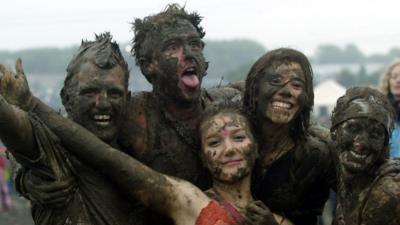 Muddy people at Glastonbury