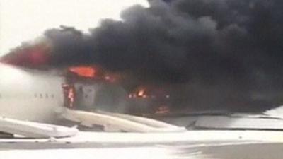 Plane on fire on Dubai runway