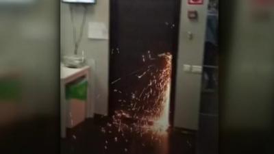 Sparks fly as officers cut open the door of the anti-corruption foundation.