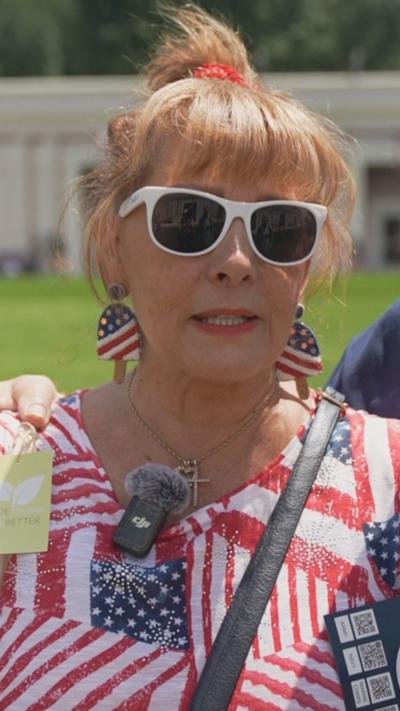 A woman in a shirt with American flag pattern.