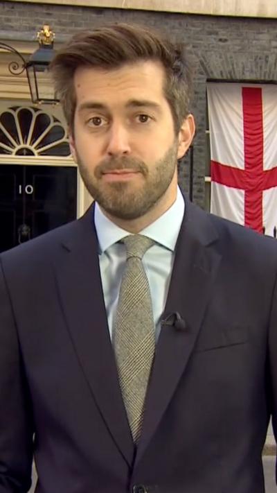 Joe Pike stands outside No 10, where a St George's flag is visible, as he looks at camera