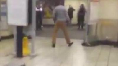 Footage shows police confront a man at Leytonstone station