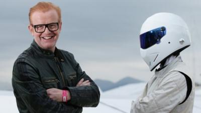 Chris Evans, left, standing with "The Stig" in Cannes