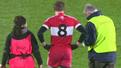 Brendan Rogers leaves the pitch at the start of the McKenna Cup Final