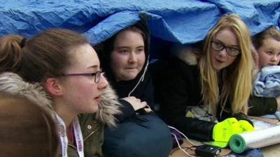 students under tent