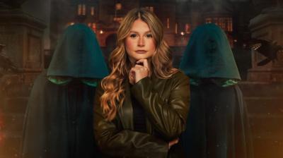 Promotional picture of Mollie in front of traitors