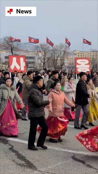 North Koreans dancing outside