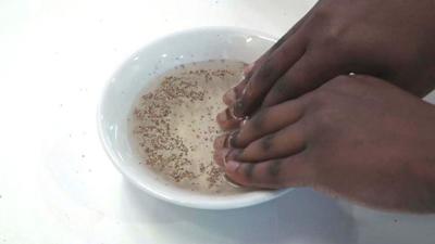 Hands going into soapy water