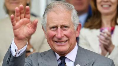 King Charles III waving.