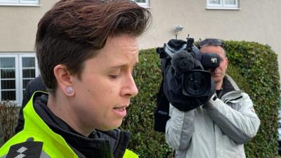 A woman reading a police statement