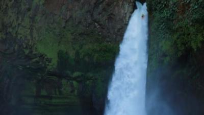 Kayak tumbilng down waterfall