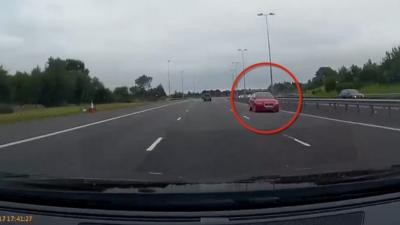 Red Audi travelling in wrong direction