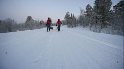 two women in trekking gear on snow