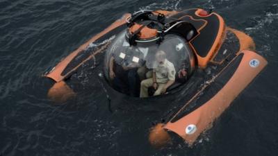 Russian President Vladimir Putin (R) is seen inside a research bathyscaphe while exploring the waters of the Black Sea