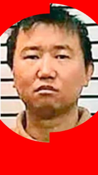 A mugshot of man with short dark hair