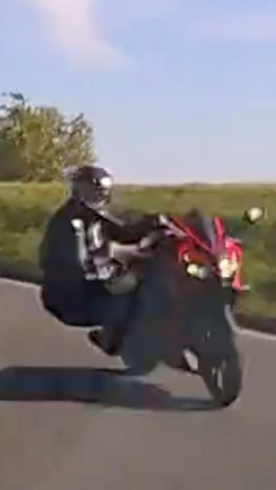Motorcyclist in black leathers on a red bike