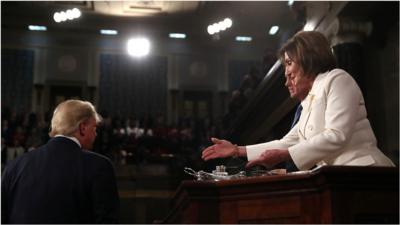 Trump turns away from Pelosi as she holds out her hand