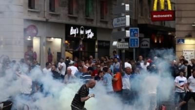 A tear gas canister explodes next to a football fan as England fans clash with police in Marseille on June 10, 2016 in Marseille, France.