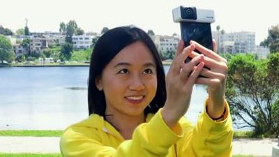 Girl holding mobile phone camera