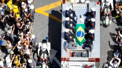 Pelé's coffin carried on a fire engine through the streets of Santos