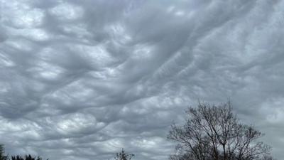 Wave-like asperitas clouds in the sky creating a grey sky tinged with white