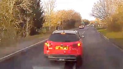 Driver blocks ambulance on road