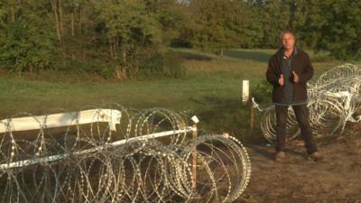 Nick Thorpe at gap in border fence