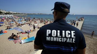 French policeman looking over Cannes beach