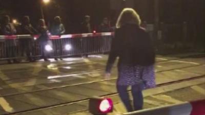 Pedestrians in Barnes run across train crossing