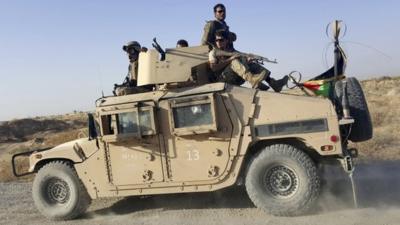 Afghan security forces on top of a vehicle outside Kunduz city on 1 October 2015