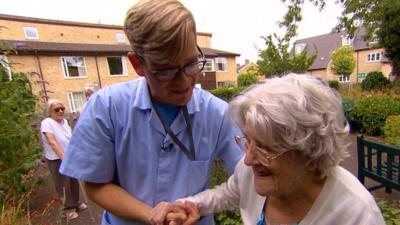 Krastan Antonov helping a care-home resident