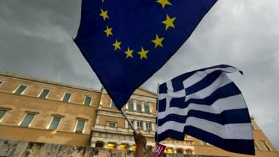 Protesters wave Greek and EU flags