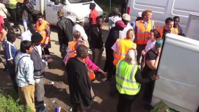 Volunteers hand out aid to Calais refugees