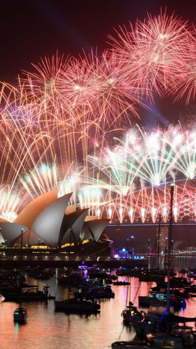 Red fireworks burst over Sydney Harbour