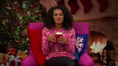 Nina with a hot chocolate in a christmas setting