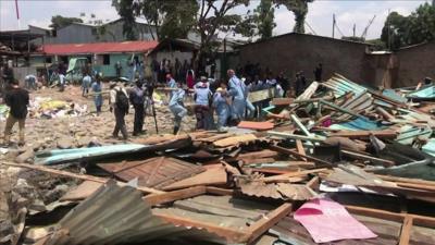 Rescue workers clear debris at the collapsed school