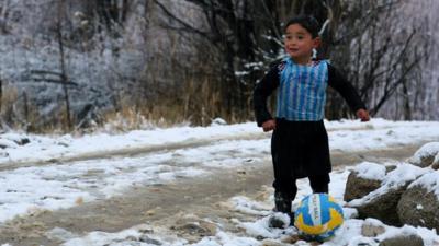 Murtaza Ahmadi, five, wears a plastic bag jersey as he plays football in Jaghori district of Ghazni province