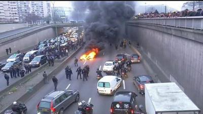 Riot police on street blocked by fire