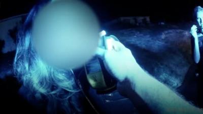 Woman being breathalysed