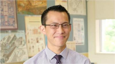 Eddie Woo sits in a classroom