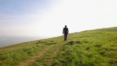 The BBC's Damian Grammaticas on a cliff top