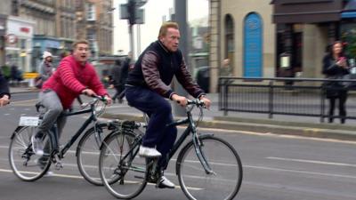 Arnold Schwarzeneggar cycling in Edinburgh