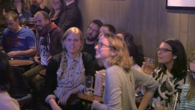 People watching election results in a bar