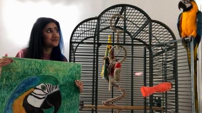 Kitty Kaur with an image of her parrot Rio