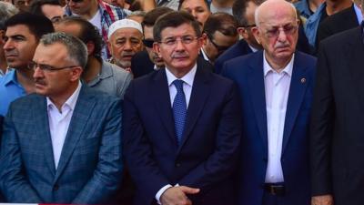 Ahmet Davutoglu (centre) at a funeral for victim (17 July 2016)