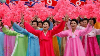 Women react as they see North Korean leader Kim Jong-un