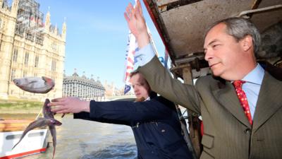 Nigel Farage throwing fish into the Thames