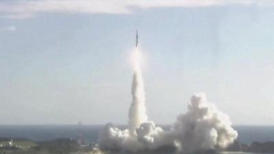 Rocket launching with sea and sky in background