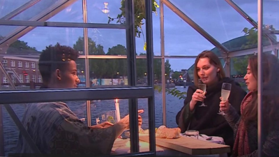 People dining in a greenhouse